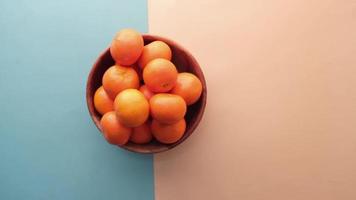 close up of man fresh orange fruits in a bowl video