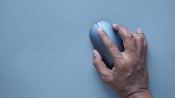 hand with computer mouse on gray color background video