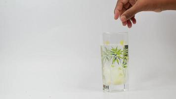 Effervescent soluble tablet pills and glass of water on white video