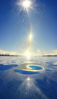 the sun shines brightly over a hole in the snow. . photo