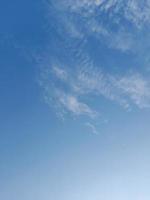 Beautiful white clouds on deep blue sky background. Large bright soft fluffy clouds are cover the entire blue sky. photo