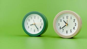 alarm clock on green background time concept working with time precious time photo