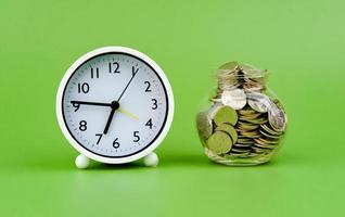 Saving coins in a glass jar Finance concept, income, profit, salary photo