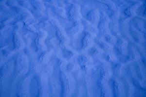 blue background with sand in the shape of sand waves photo