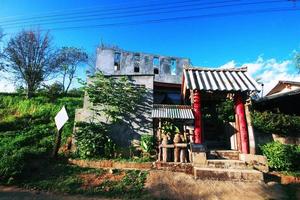 Yunnan Chinese hilltribe houses on the mountain with beautiful blue sky and sunlight in northern Thailand photo