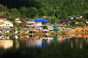 Beautiful landscape village on mountain and blue sky reflection in lake and river at Meahongson province, Thailand photo