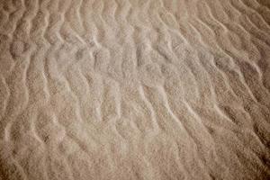 beige background with sand in the shape of sand waves photo