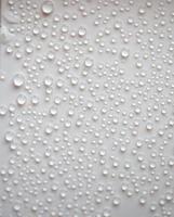 small fine round droplets on a white background photo