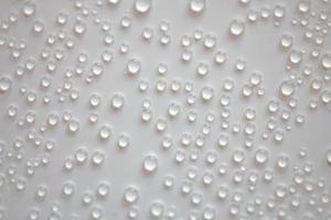 small fine round droplets on a white background photo