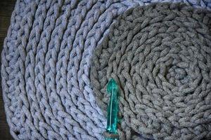 grey handmade cottoncord tablecloths on crochet hook photo