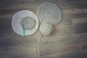 grey handmade cottoncord tablecloths on crochet hook photo