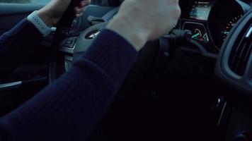 Close-up view of the male hands on the steering wheel driving the car video