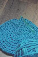 Blue crochet knitting manual pad on the table hand knitting, photo