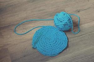 Blue crochet knitting manual pad on the table hand knitting, photo