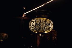 original oriental lamp shining with warm light during the coming dark photo