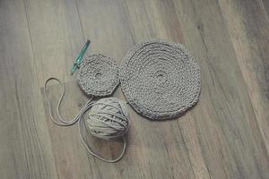 grey handmade cottoncord tablecloths on crochet hook photo