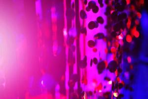 Glamour Ultra Violet sparkling and purple glitter bokeh of metallic circle. Multicolored Christmas and New Year glowing light abstract for Christmas and holiday concept. photo
