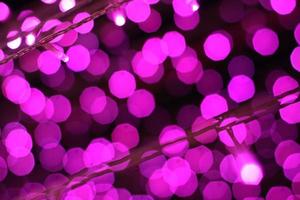 Glamour Ultra Violet sparkling and purple glitter bokeh of metallic circle. Multicolored Christmas and New Year glowing light abstract for Christmas and holiday concept. photo