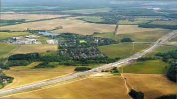 View from the airplane window on beautiful summer fields and forests. Panoramic scenic view of over countryside fields landscape in Kaliningrad video