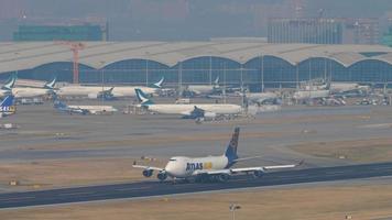 HONG KONG NOVEMBER 10, 2019 - Cargo Boeing 747 AtlasAir accelerates before takeoff, Chek Lap Kok International Airport, Hong Kong HKG. Long shot, huge cargo jumbo jet flies away video