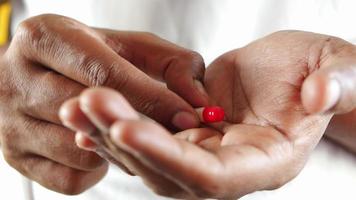 top view of pill on persons hand video