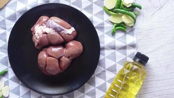 Raw fresh lamb kidneys on a chopping board video