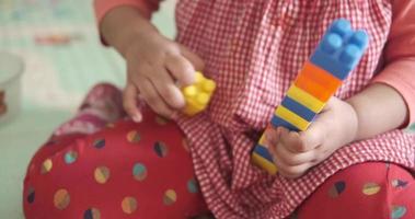 Baby child playing with colorful building blocks video