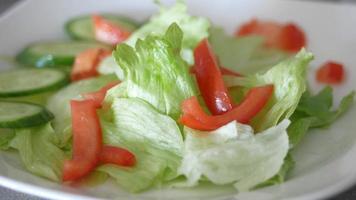 Close up of fresh vegetable salad in a bowl on table video