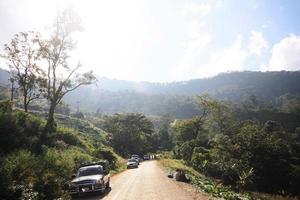 Life of hill tribe farmers and car parking beside country road on the mountain in Thailand photo