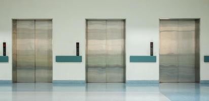 Front View of Three Doors in Elevator with Closed Doors photo