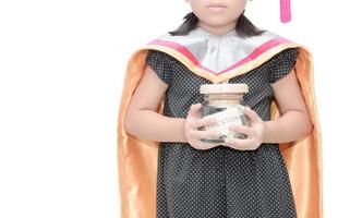 kid holding education money savings in a glass jar photo