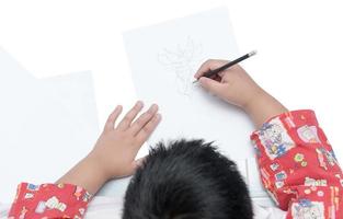 boy drawing cartoon on white paper isolated photo