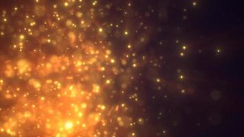 Abstract yellow gold energy particles and dots glowing flying sparks festive with bokeh effect and blur background, 4k video, 60 fps video