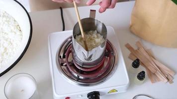 Woman making decorative aroma candle at table video