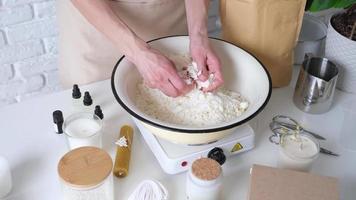 Woman making decorative aroma candle at table video