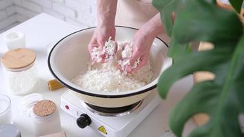 Woman making decorative aroma candle at table video