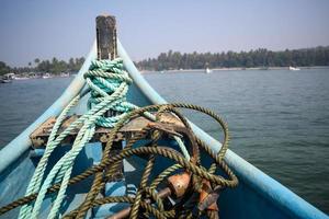 Amazing view from over long tail motor boat in Arabian sea in Goa, India, Ocean view from wooden boat with old ropes photo