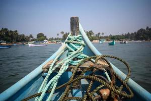 Amazing view from over long tail motor boat in Arabian sea in Goa, India, Ocean view from wooden boat with old ropes photo