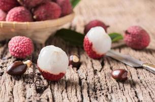 Fresco orgánico lychee Fruta en antiguo madera antecedentes foto