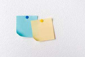 Yellow and blue POST-IT NOTES on foam plate photo
