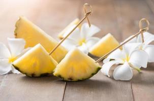 sliced pineapple on wood background photo