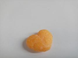 close up of love shaped snack on white background,with copy space area. photo