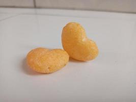 close up of love shaped snack on white background,with copy space area. photo