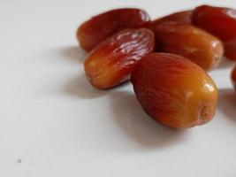 Pile of tasty dry dates isolated on white background. Arabic food photo