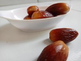 Pile of tasty dry dates isolated on white background. Arabic food photo