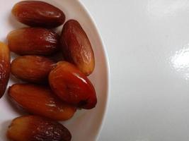 Pile of tasty dry dates isolated on white background. Arabic food photo