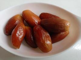 Pile of tasty dry dates isolated on white background. Arabic food photo