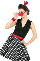 Retro girl in red glasses on a white background. Fifties style photo