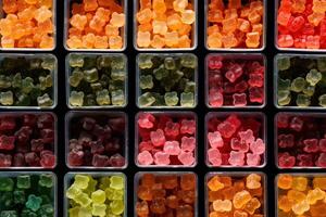 illustration of vast array of different gummy bear flavors in open square containers photo