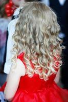 Rear view of a little girl with beautiful blond hair. photo